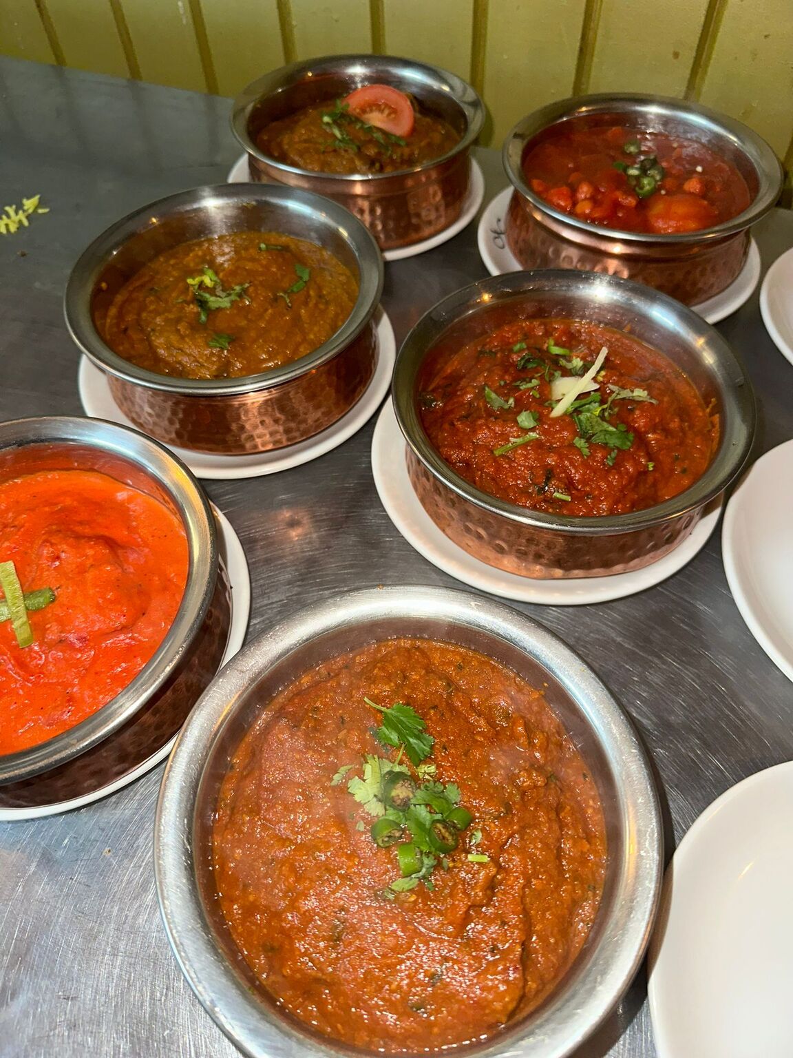 A variety of Indian curries in copper bowls at MariGold Restaurant, Kilmacolm. 