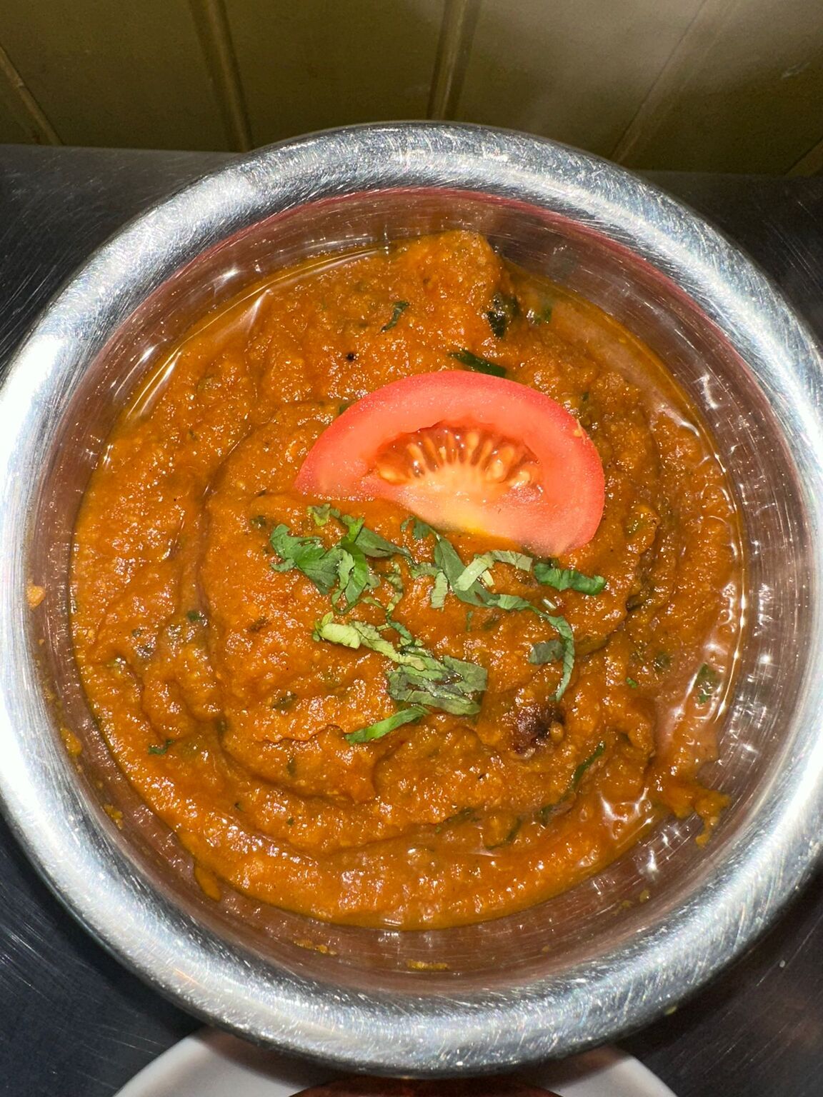 A deep, aromatic Rogan Josh curry garnished with fresh ginger slivers and 
coriander, served at MariGold in Kilmacolm. 